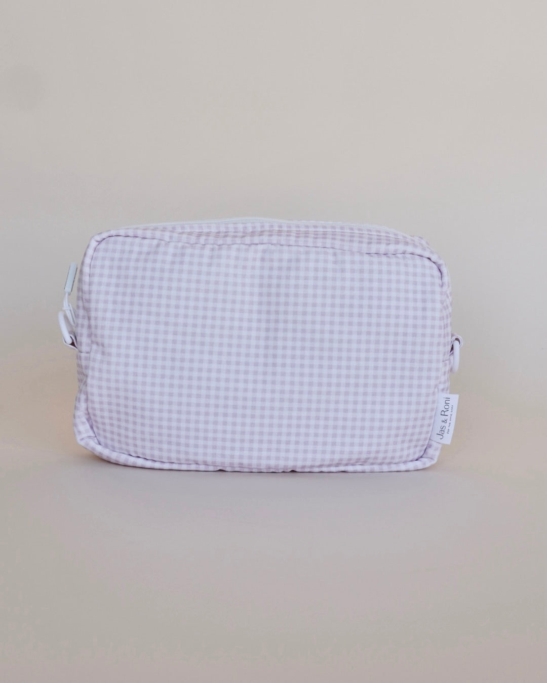 Bolsa neceser a cuadros rosas en fondo beige